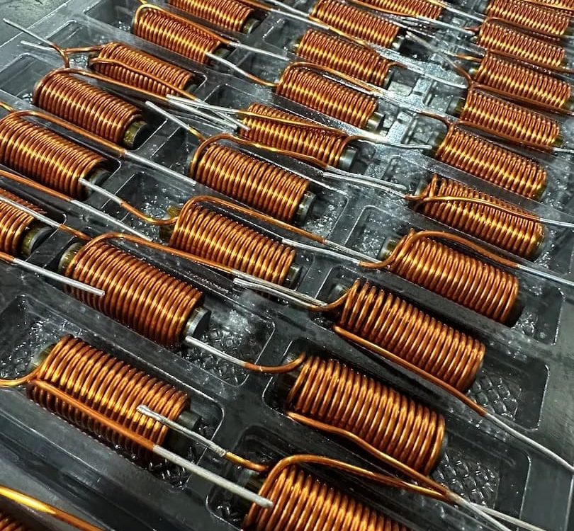 tray of Inductor windings on ferrite rod